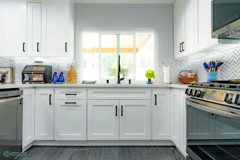 Santa Clarita white kitchen remodel with a herringbone backsplash and dark wood floors.
