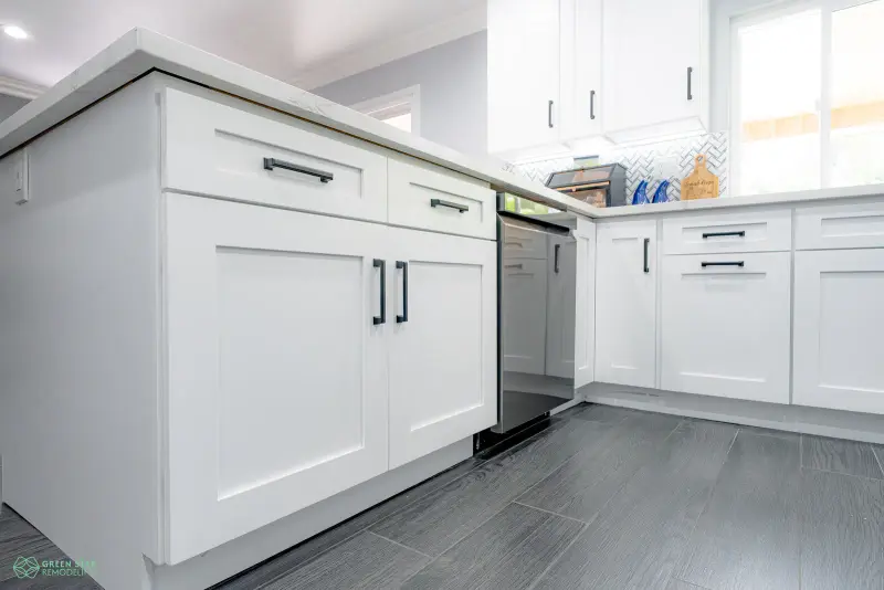 White shaker kitchen cabinets paired with dark wood floors in a Santa Clarita remodel.